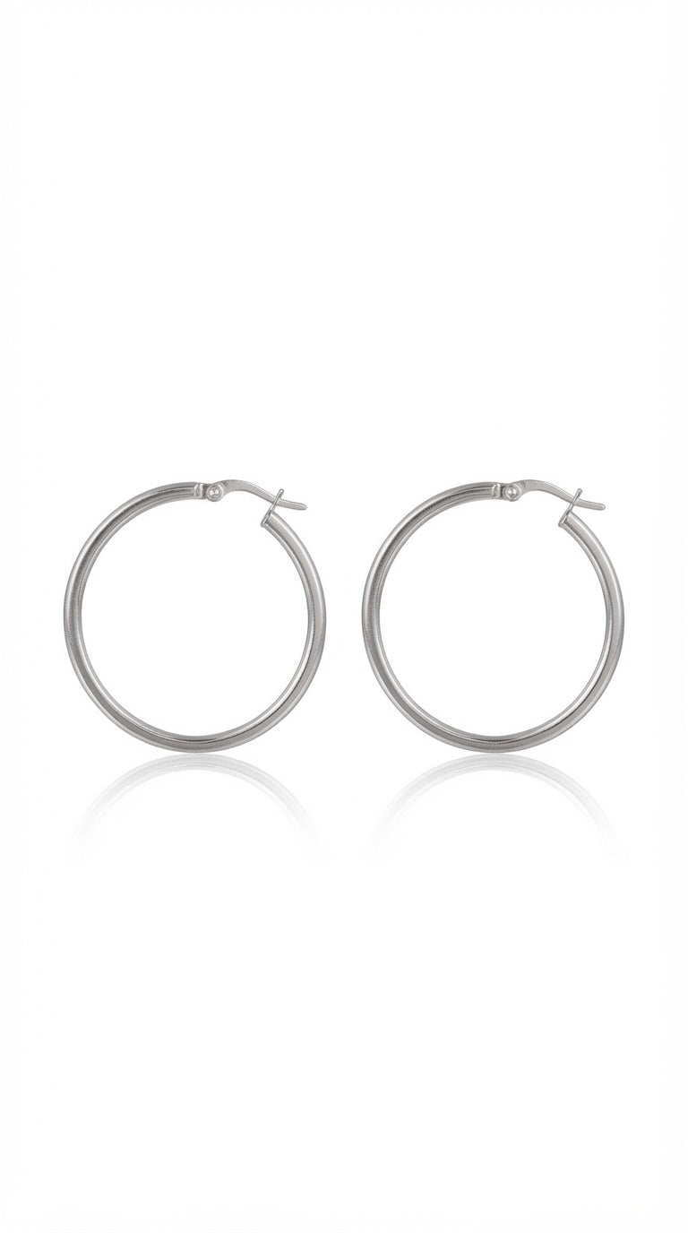 The Stevie Hoops, 30mm sterling silver hoop earrings on a plain background